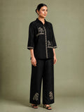 AI-styled view of black botanical motif co-ord set with collared top and wide-leg trousers